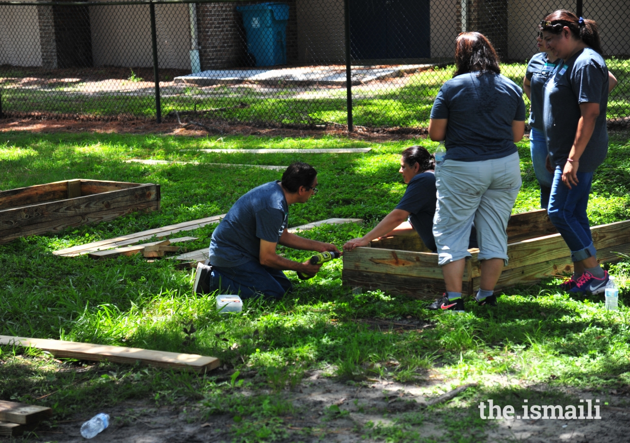 Nadir Merchant putting the final touches to wooden garden frame