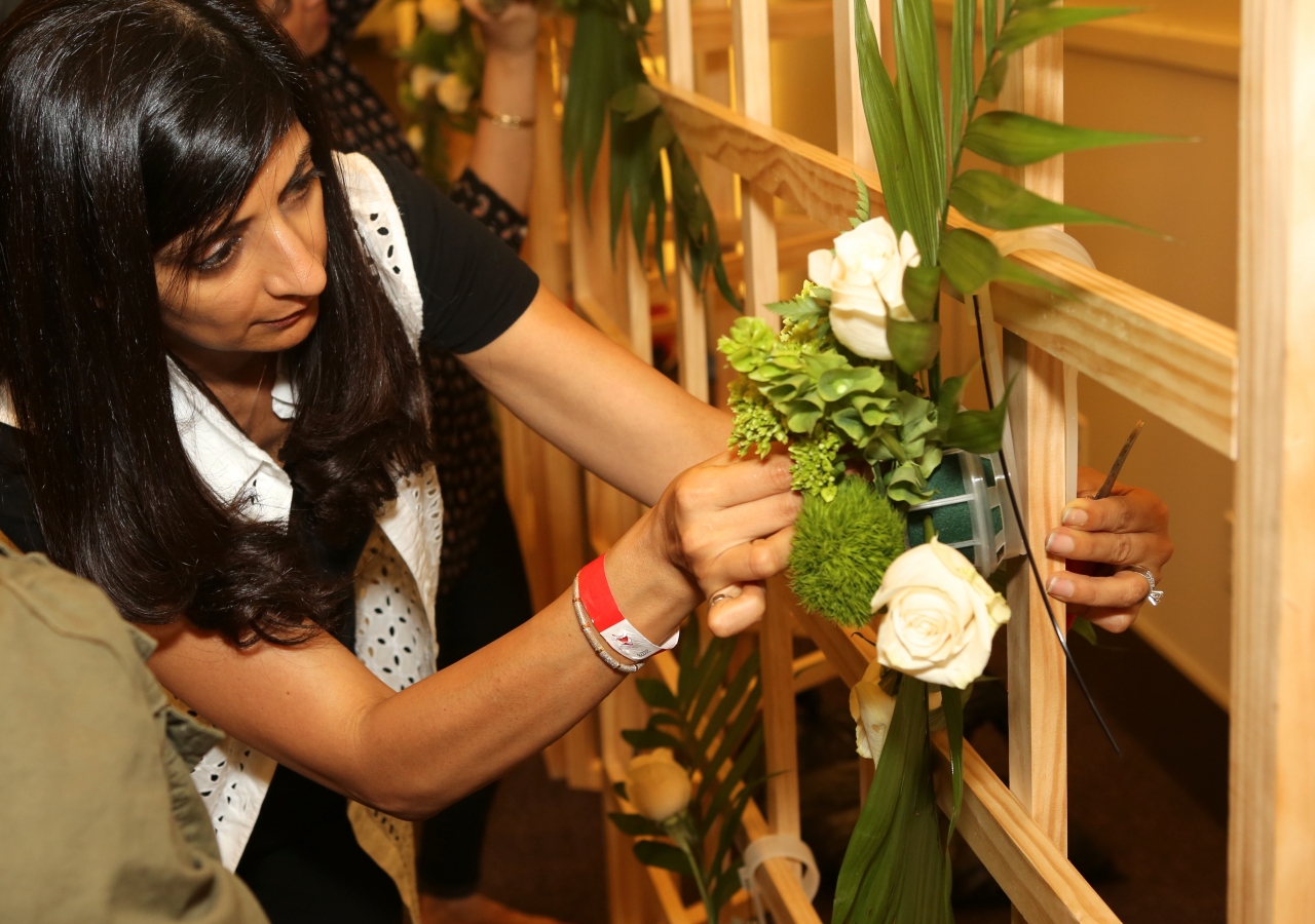 Floral team volunteer affixing flowers.