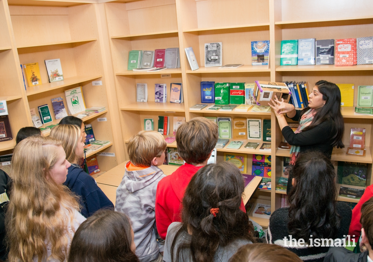 Neelam Hussain, a STEP teacher, demonstrates how to operate a makeshift camera obscura in the library.