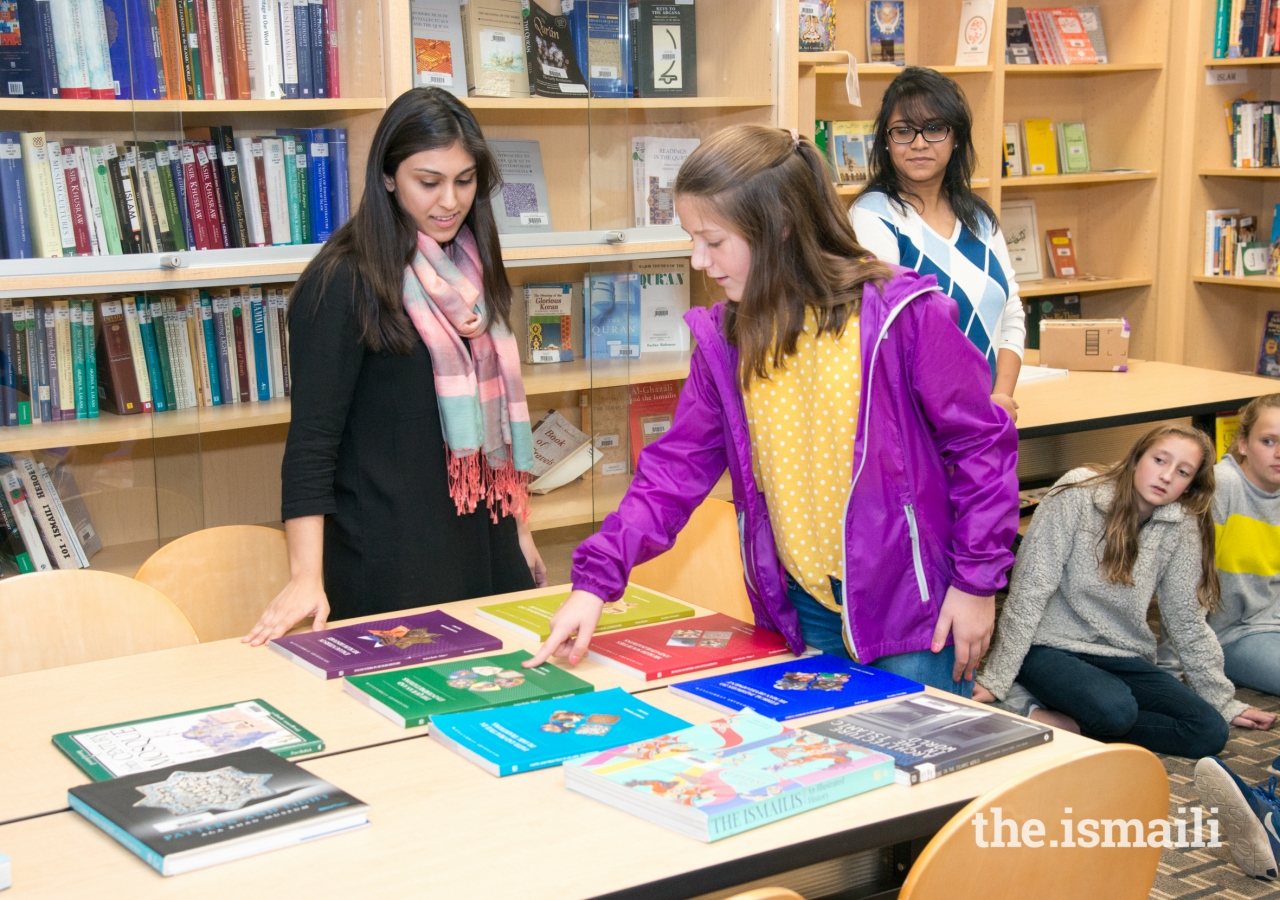 A Westminster student selects a book for discussion during an interactive activity at the library.