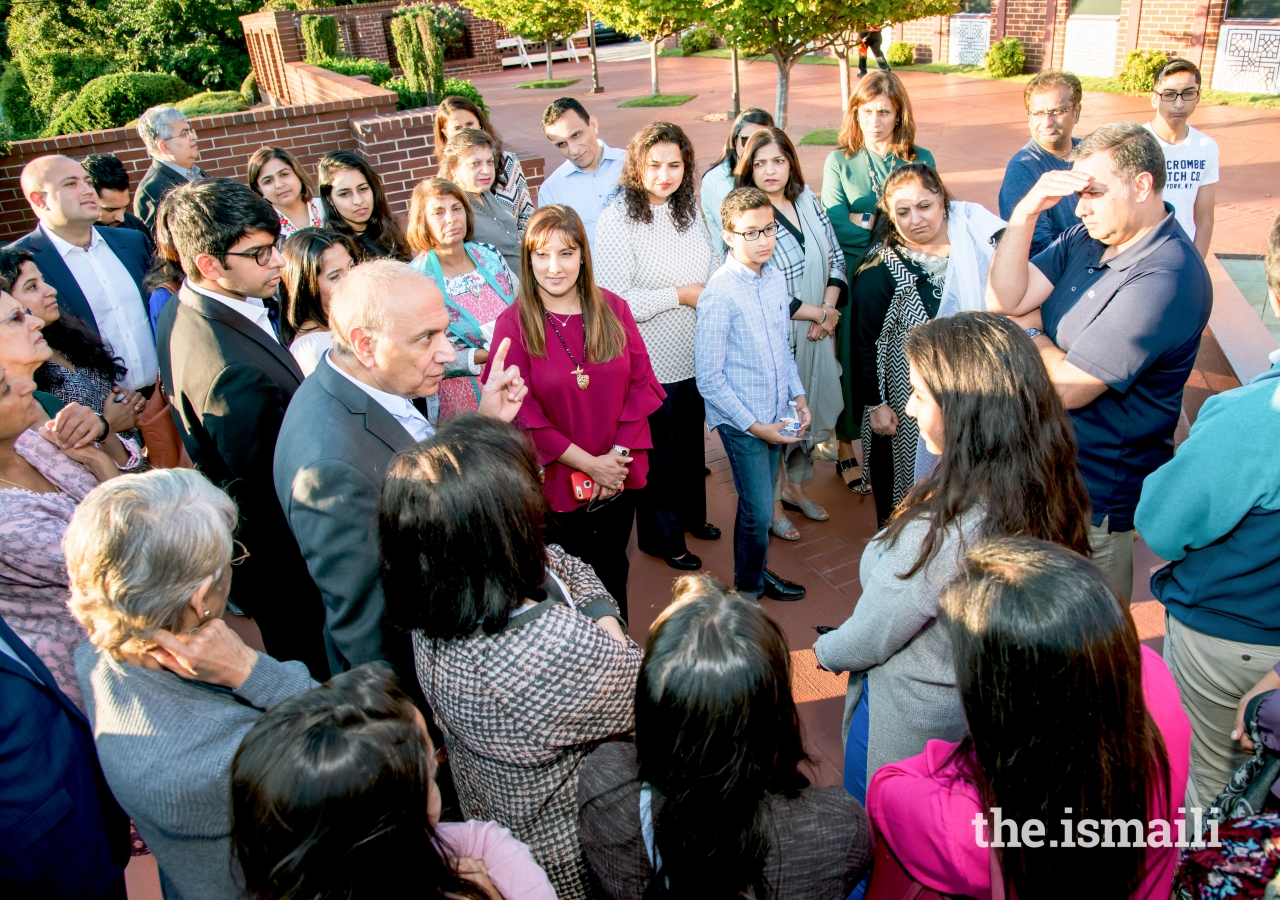 Farouk Noormohamed guides a tour of the Ismaili Jamatkhana in Decatur, Georgia. He draws attention to various symbols of Islam incorporated into the architecture of the main courtyard.