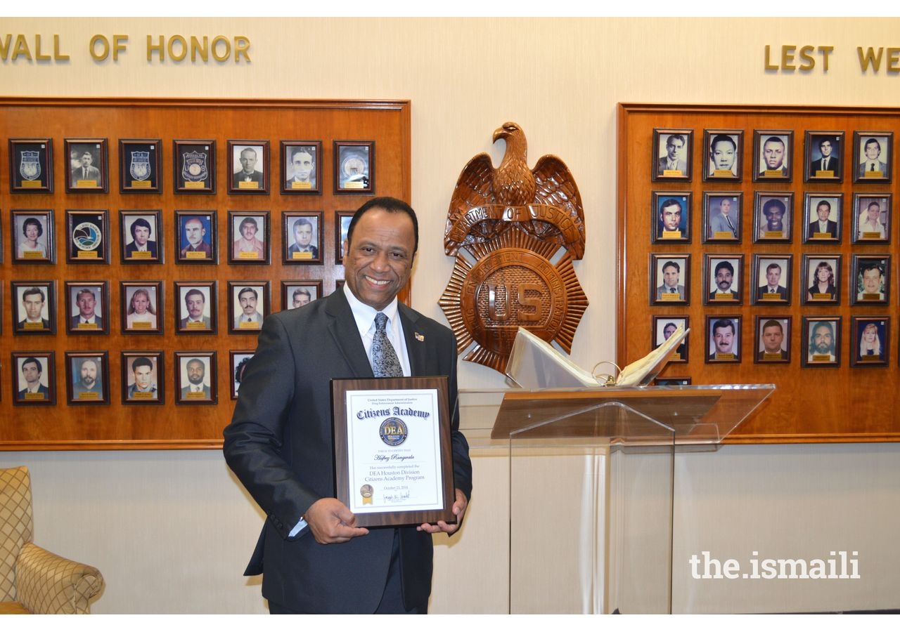 Hafeez Rangwala receiving a plaque for being a  volunteer with the Drug Enforcement Agency’s Citizen Academy