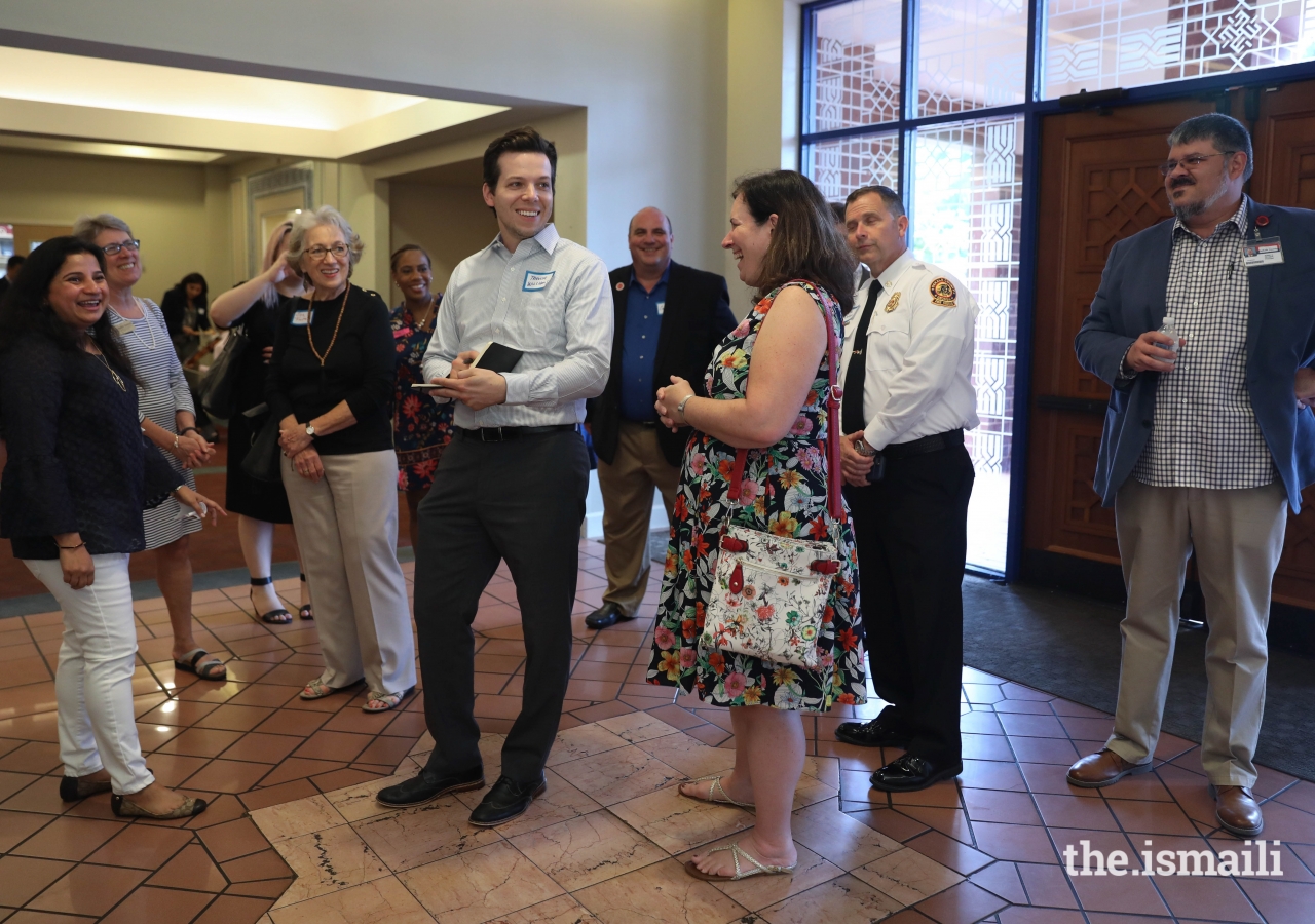 Commissioner Kathie Gannon of DeKalb County, Trevor Williams of Global Atlanta, and others get a tour of the Ismaili Jamatkhana from volunteer Dr. Nadya Merchant.