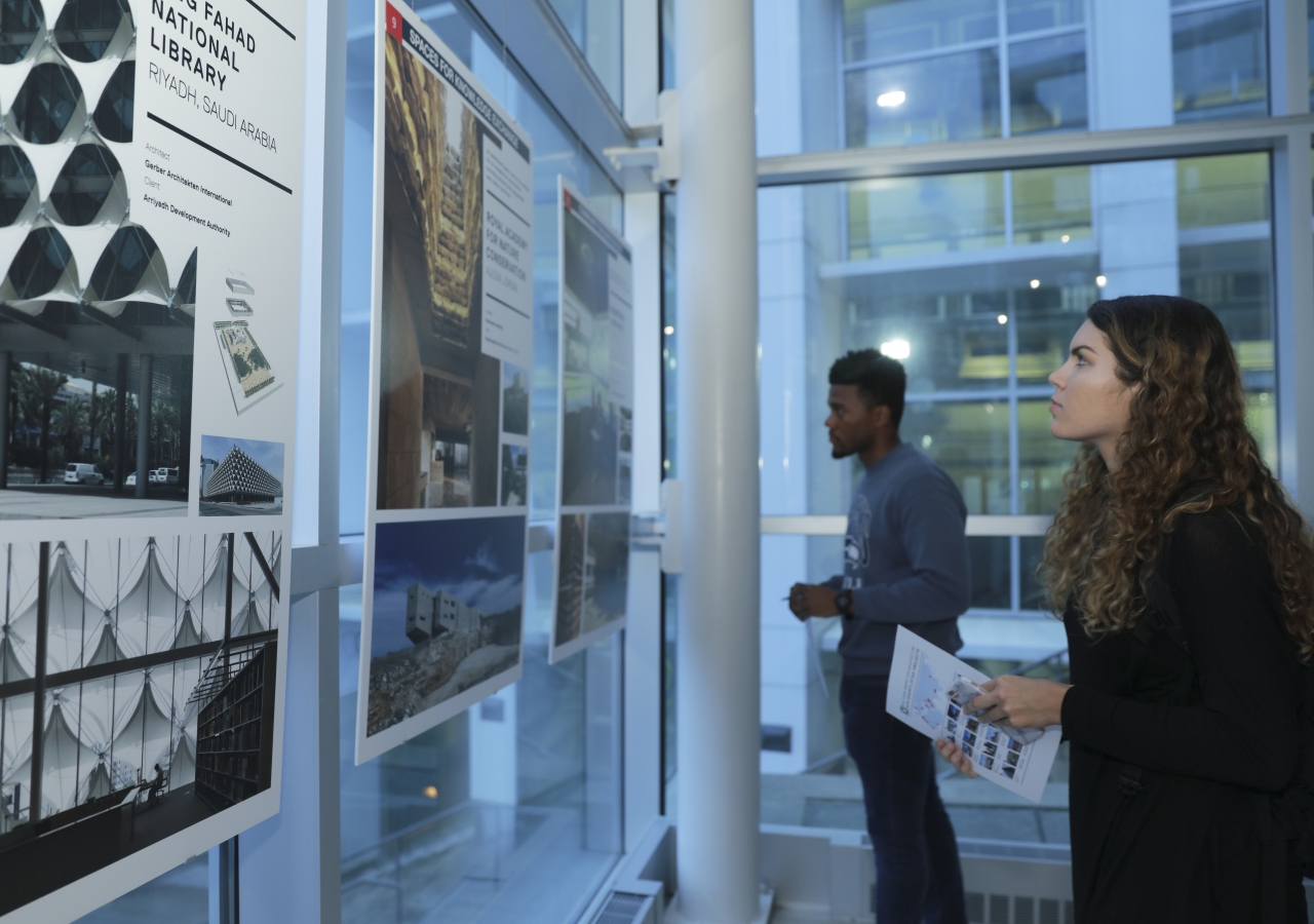 Young students study the various nominated and winning projects of the 2016 Aga Khan Award for Architecture cycle displayed at the exhibition.