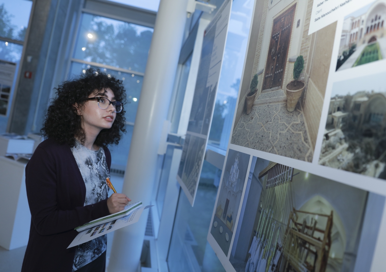 Young students study the various nominated and winning projects of the 2016 Aga Khan Award for Architecture cycle displayed at the exhibition.