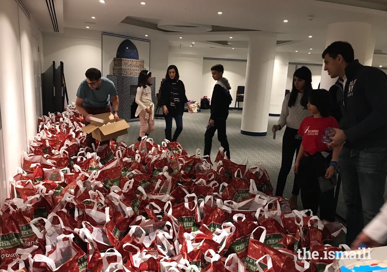 Members of the Jamat in the UK gather to pack sustenance bags for homeless and vulnerable individuals in London.