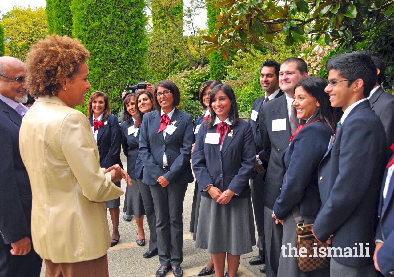 Michaëlle Jean, former Governor General of Canada, speaks with volunteers in the courtyard at the Ismaili Centre Burnaby.