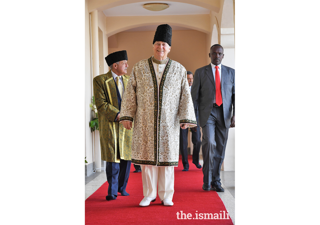 Mawlana Hazar Imam making his way to the Darbar hall to meet with the Ugandan Jamat, followed by President Minaz Jamal.