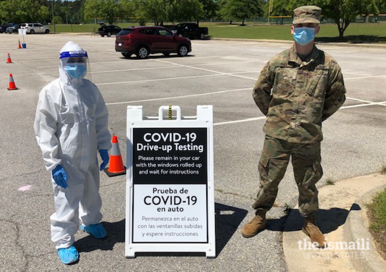 Shama Sarangi-Virani at a COVID-19 test site with a member of the National Guard.