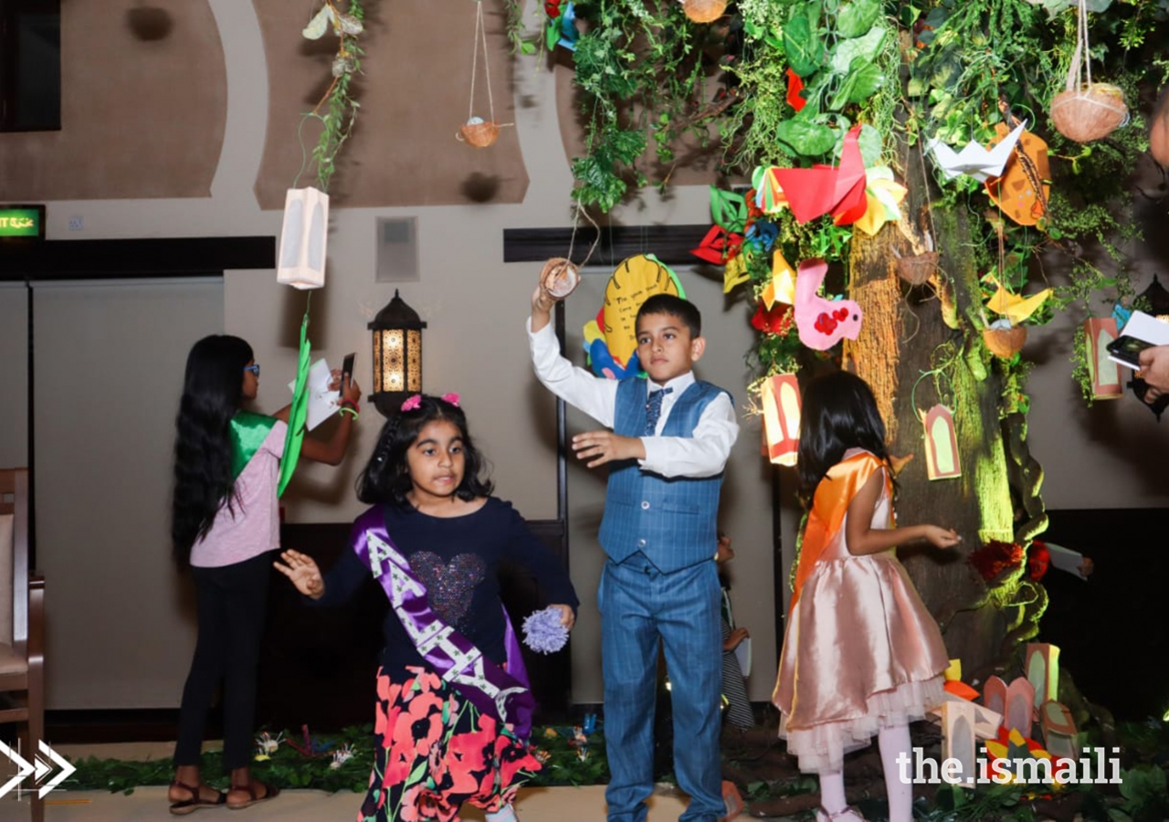 Young artists placing their beautiful creations on the tree.