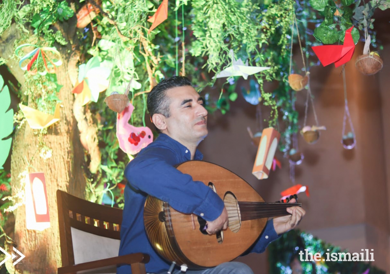 One of the soulful musicians playing the Oud with the DiversiTree in the background.