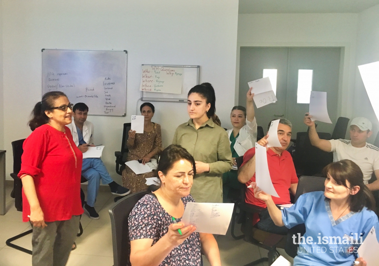 Shirin Nanjee working on English vocabulary lessons with AKMCK clinicians and staff members.