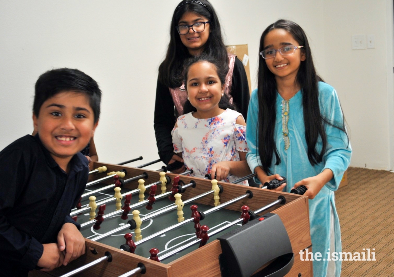 Younger members enjoy group activities during Game Night in Miami.