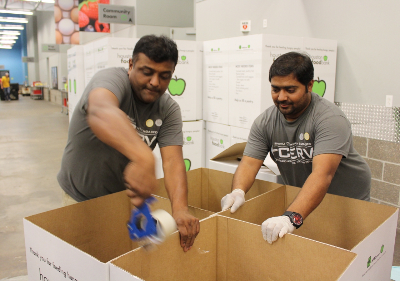 I-CERV Volunteers assemble boxes to sort through donations at Houston Food Bank.