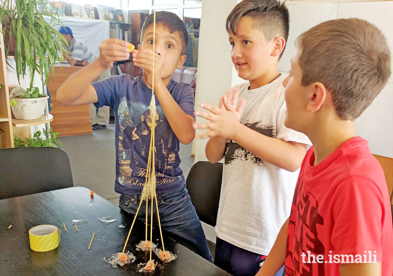 Students try an engineering challenge: to build the tallest tower they can in the time limit using only gummy pieces and spaghetti.