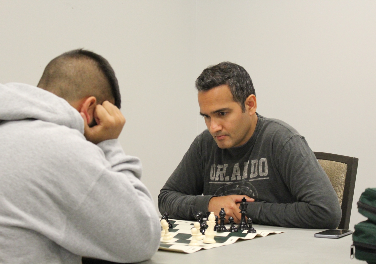 Two Jamati members engage in a chess match