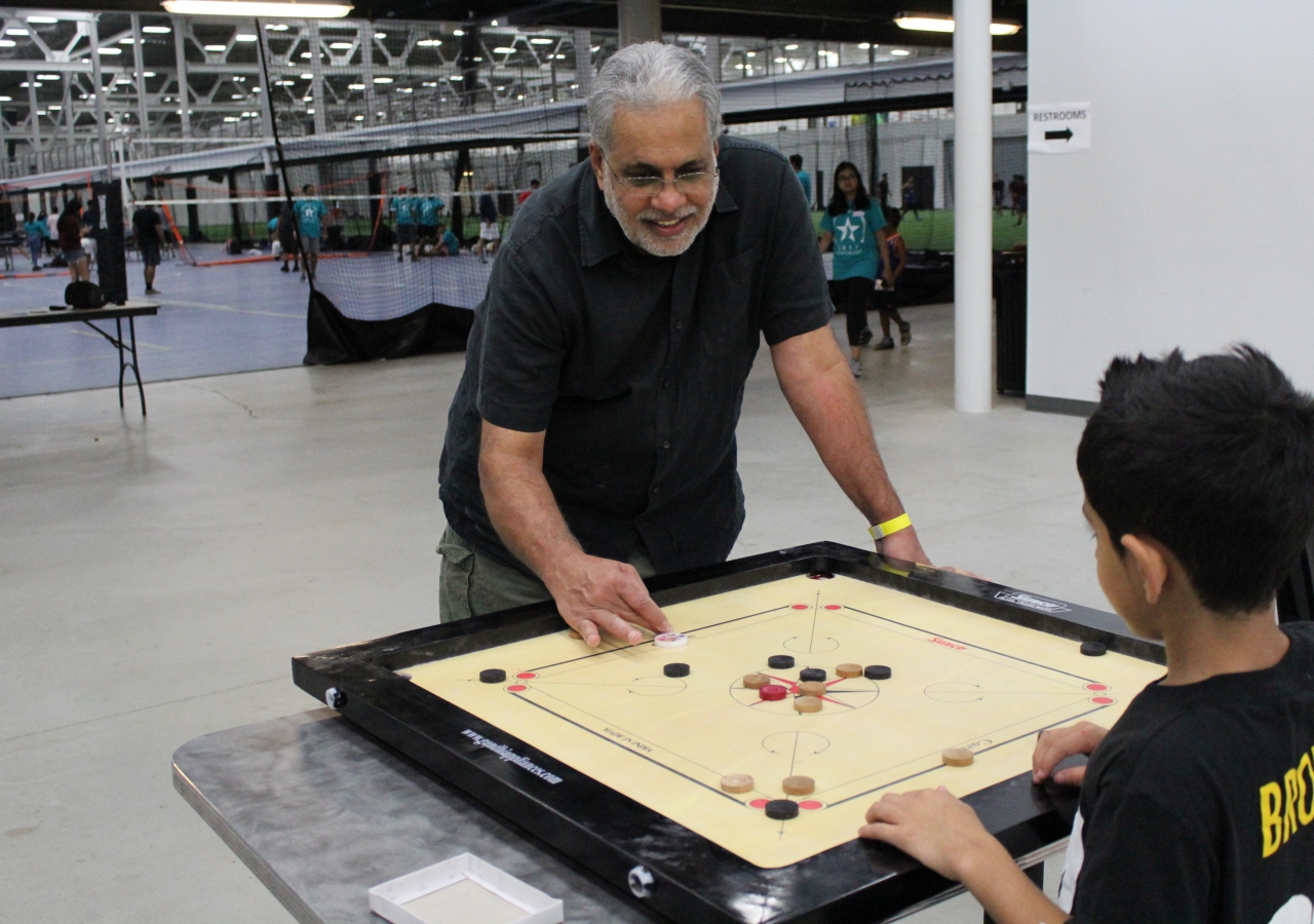 Young and old come together for a friendly game of carom