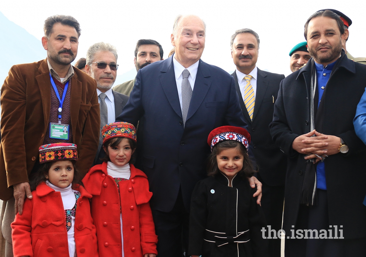 Mawlana Hazar Imam joins children for a group photograph at the Gilgit airport 