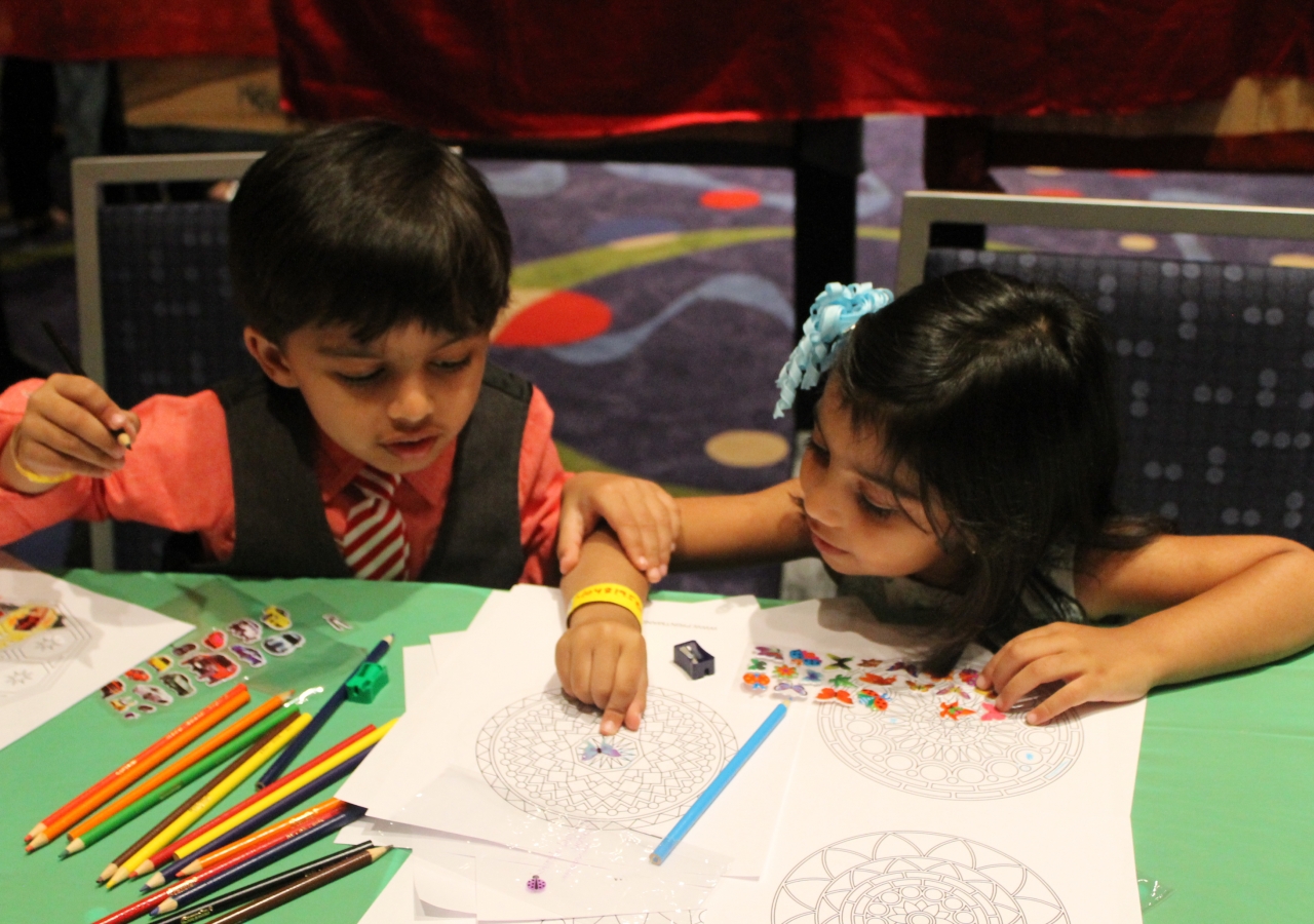 Two young children pick up on subtle themes and messages that were hidden in the Early Childhood section of the Reflections Lounge.