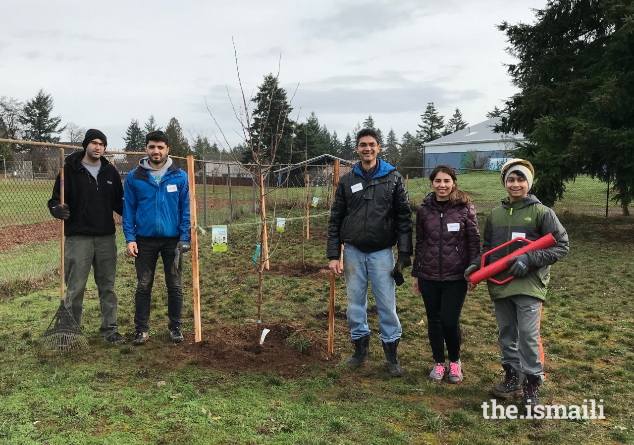 Portland’s (left to right) Abid Valji, Buzurgmehr Dodkhudoev, Mukhi Saheb Amyn Premji, Sepideh Azizi, and Ayaan Premji, stand next to the beech tree they planted.