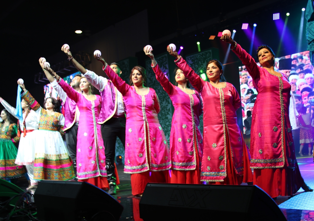 One Jamat dance performance hold orbs to the sky to symbolize the Light of Imamat.