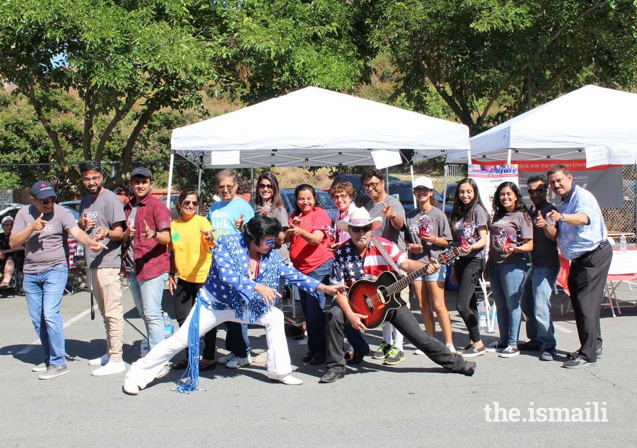 The northern California I-cerv team at San Jose’s 4th of July event takes a picture with an Elvis impersonator and his guitarist.