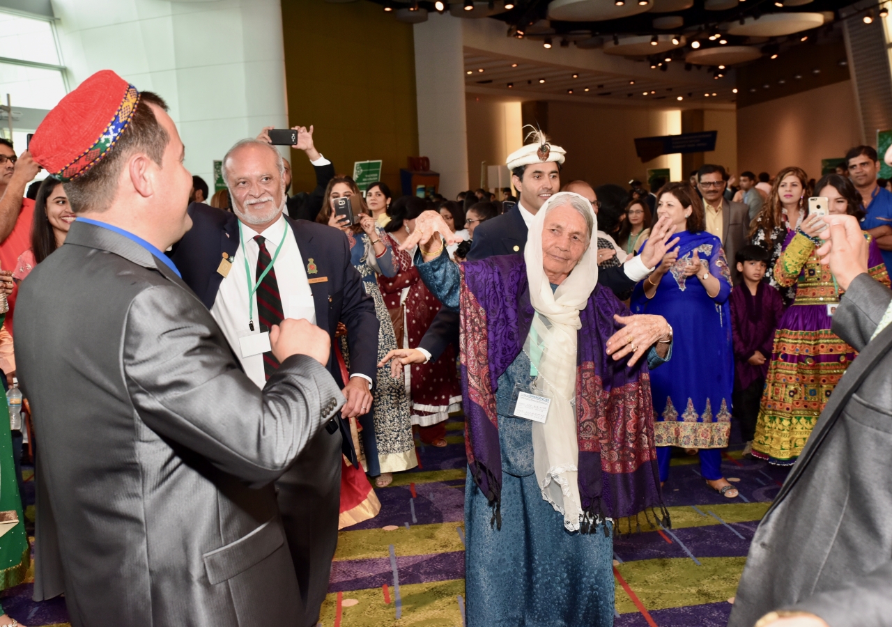 80-year-old Mosalima Altafi joins the Jamat in a traditional Afghani dance as people arrive for the Diamond Jubilee celebrations on July 11, 2017.