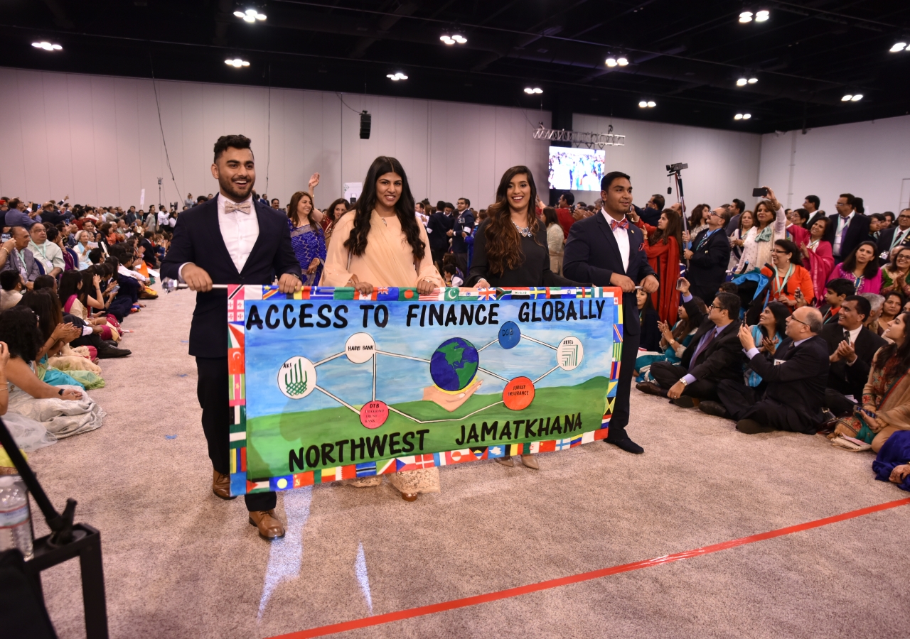 Banners showcasing the Diamond Jubilee goals are carried by the youth of various Jamatkhanas in the Southeast region