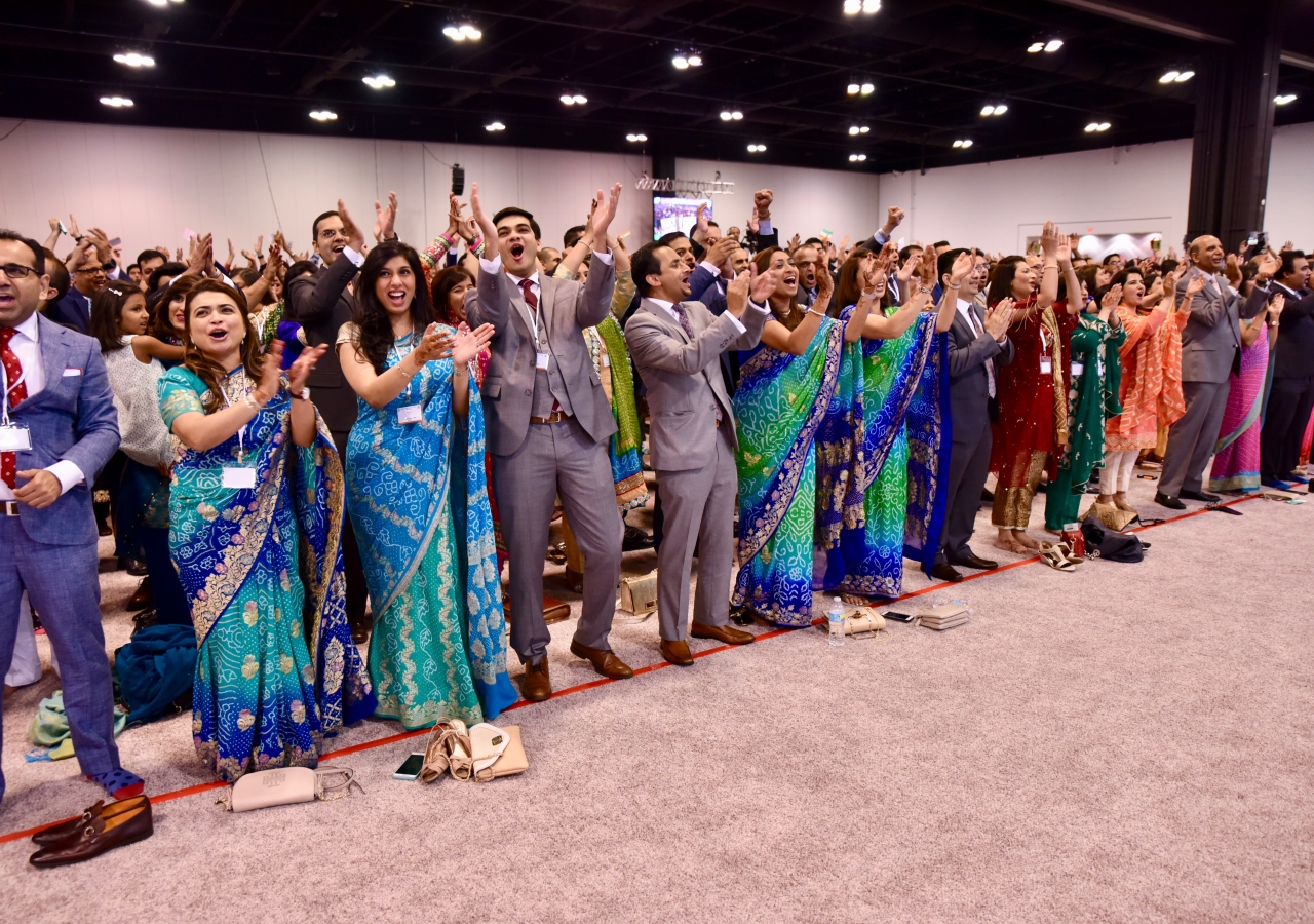 A jubilant crowd participates in the One Jamat chant