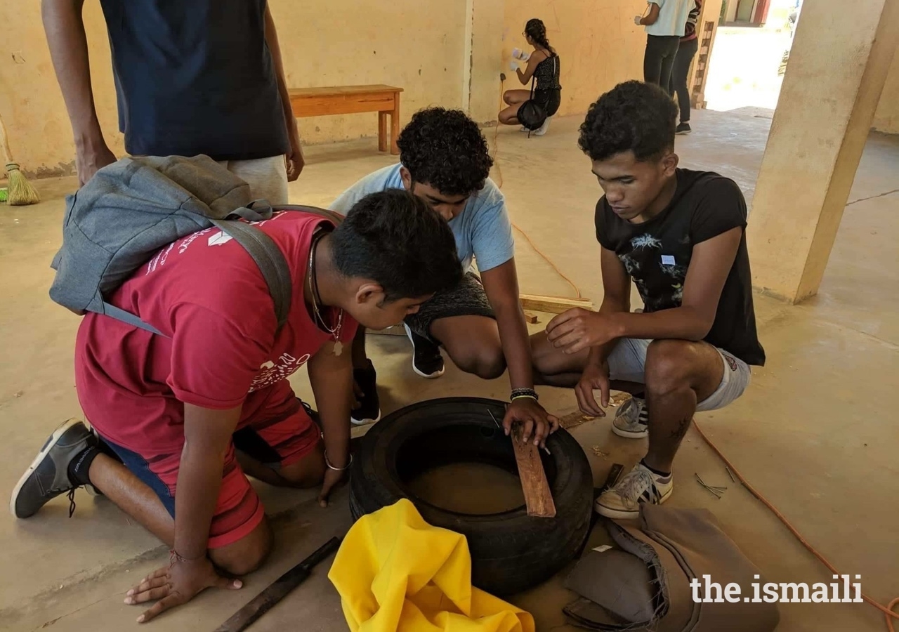 Secondary Bait-ul ilm students making a footstool with recycling materials.