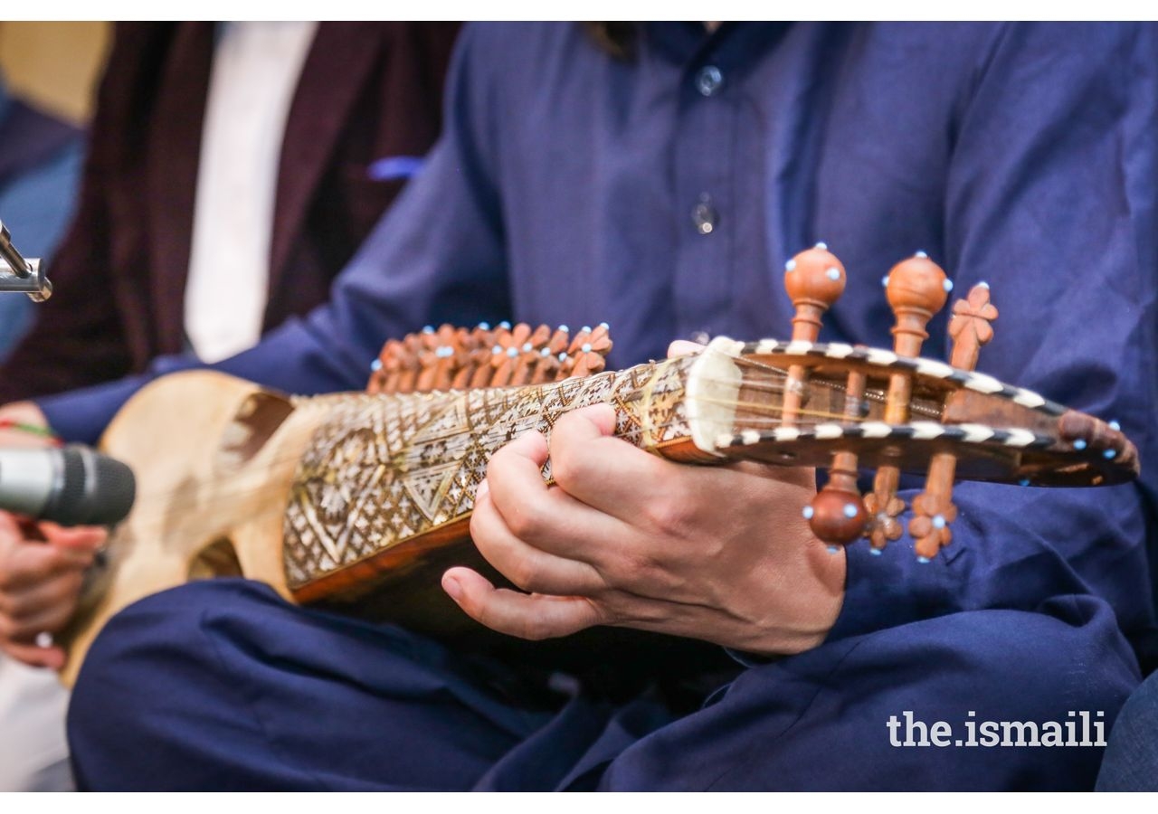 A Hunza resident, playing Charda, a regional guitar-like, five-string instrument at a community gathering performance.