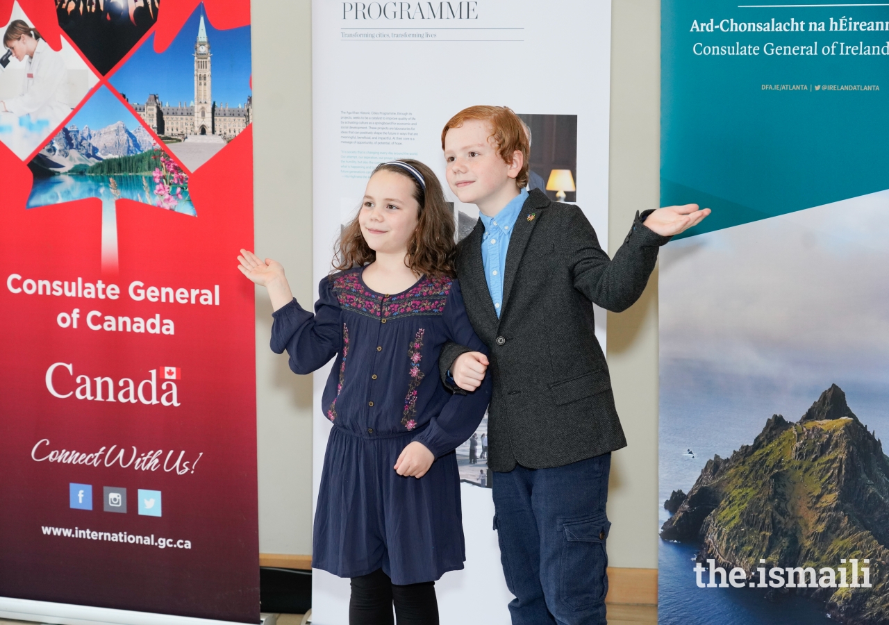 Young siblings attending the International Day screening of The Breadwinner strike a balance pose for gender equality.