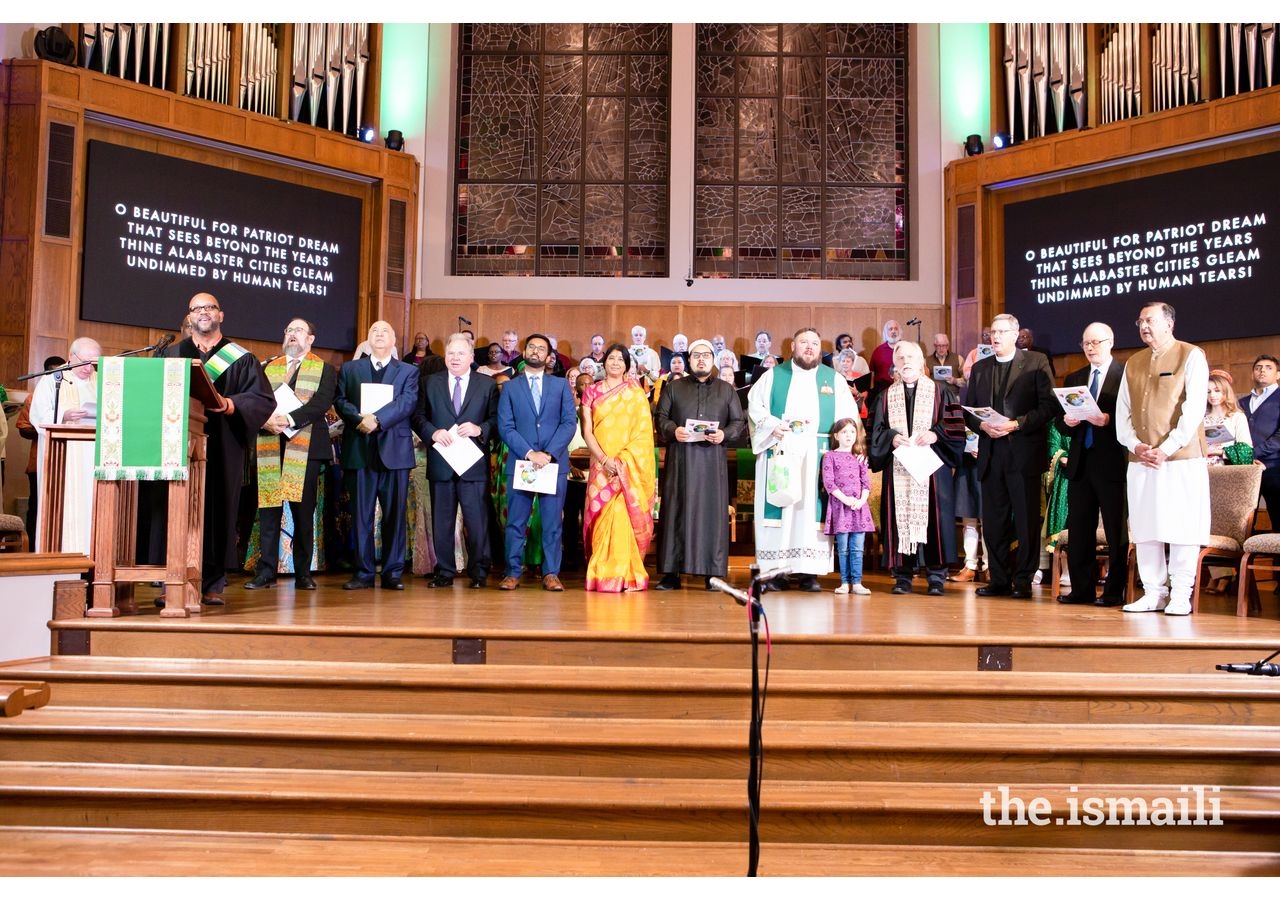 Representatives and members of the various faith-based communities came together on stage for the performance of America the Beautiful.