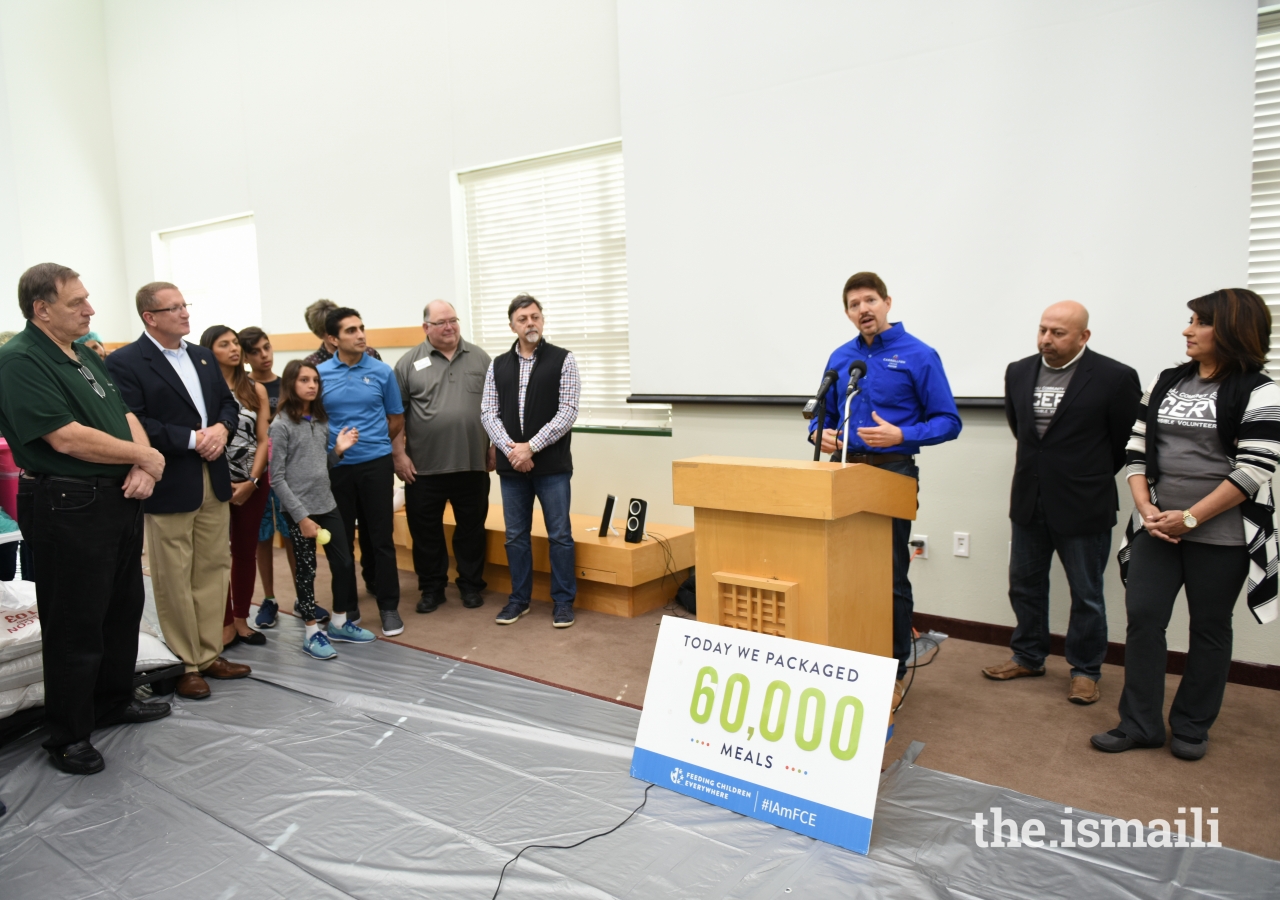 Carrollton Mayor Kevin Falconer, along with other officials, participated in this effort and addresses the volunteers when they arrived at the 60,000-meal mark.