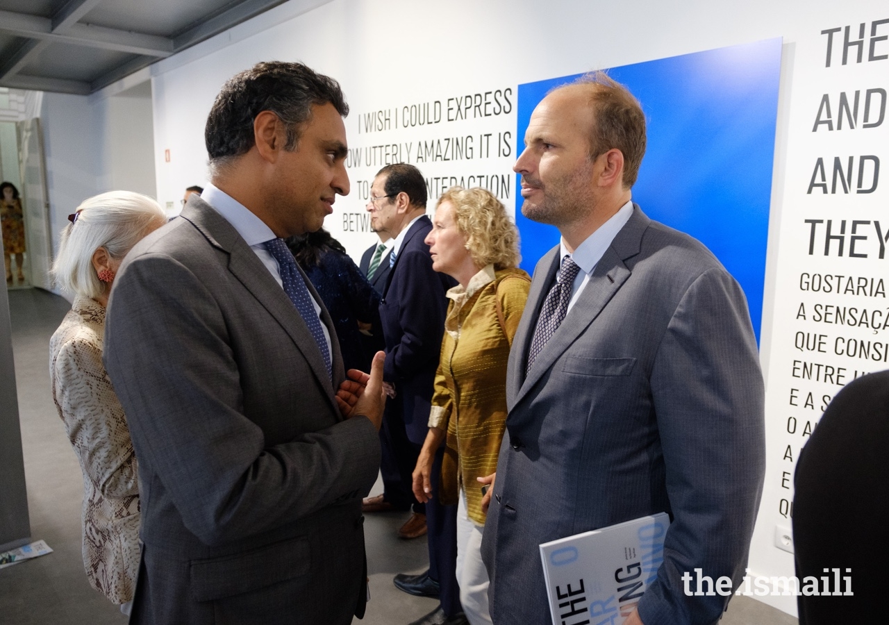 Prince Hussain in conversation with President of the Ismaili Council for Portugal, Rahim Firozali, at the inauguration of The Living Sea photo exhibition.