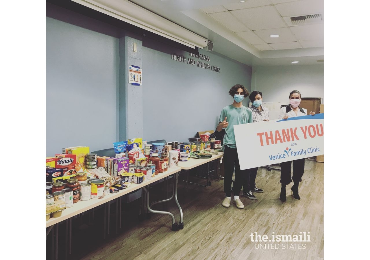 Jaden Amersi Anselmo with donated items and volunteers at Venice Family Clinic.