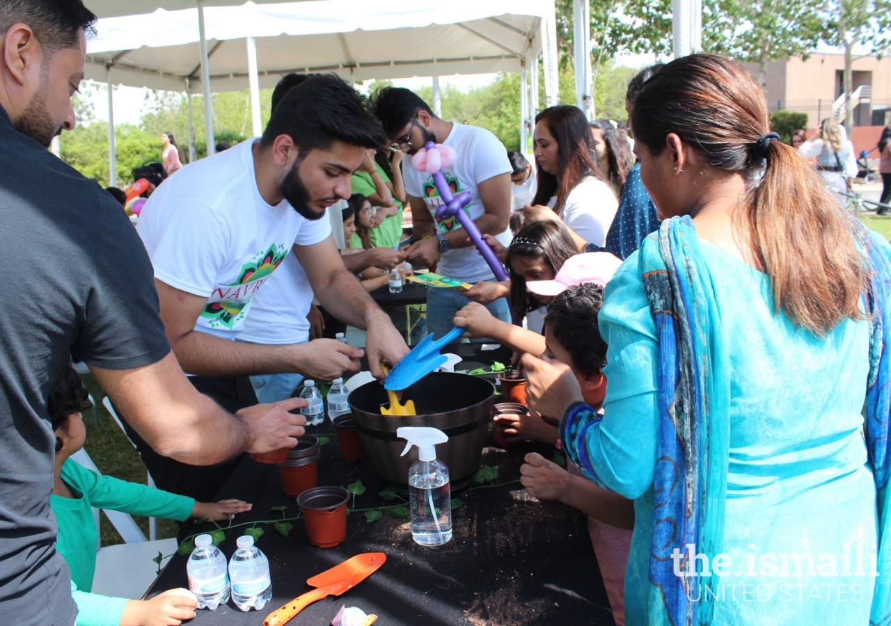 Planting flowers to take home and grow at the New Leaf booth.