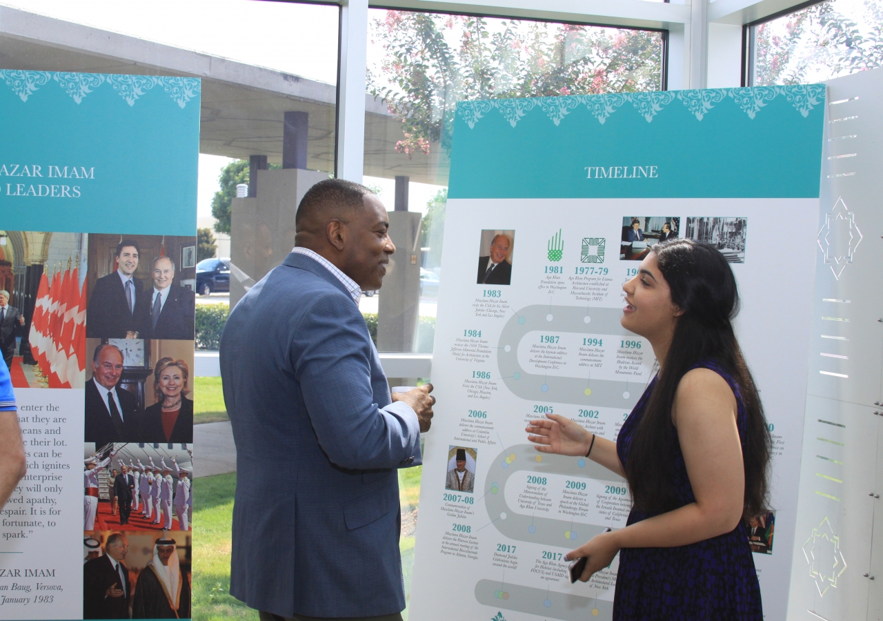 Student guide Jasmine Babool giving Mayor Harry LaRosiliere an an overview of Mawlana Hazar Imam’s Diamond Jubilee and work of the Aga Khan Development Network.