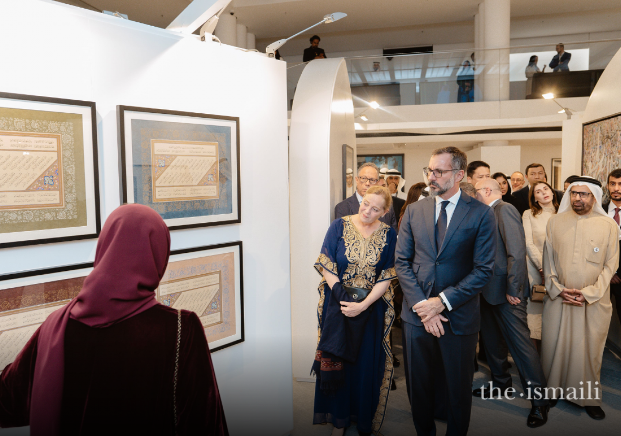 Fatma Al Mahmoud, a curator of the Al Burda Exhibition, showcases artwork to guests including Prince Rahim and Dr Ulrike Al-Khamis, Director and CEO of the Aga Khan Museum.