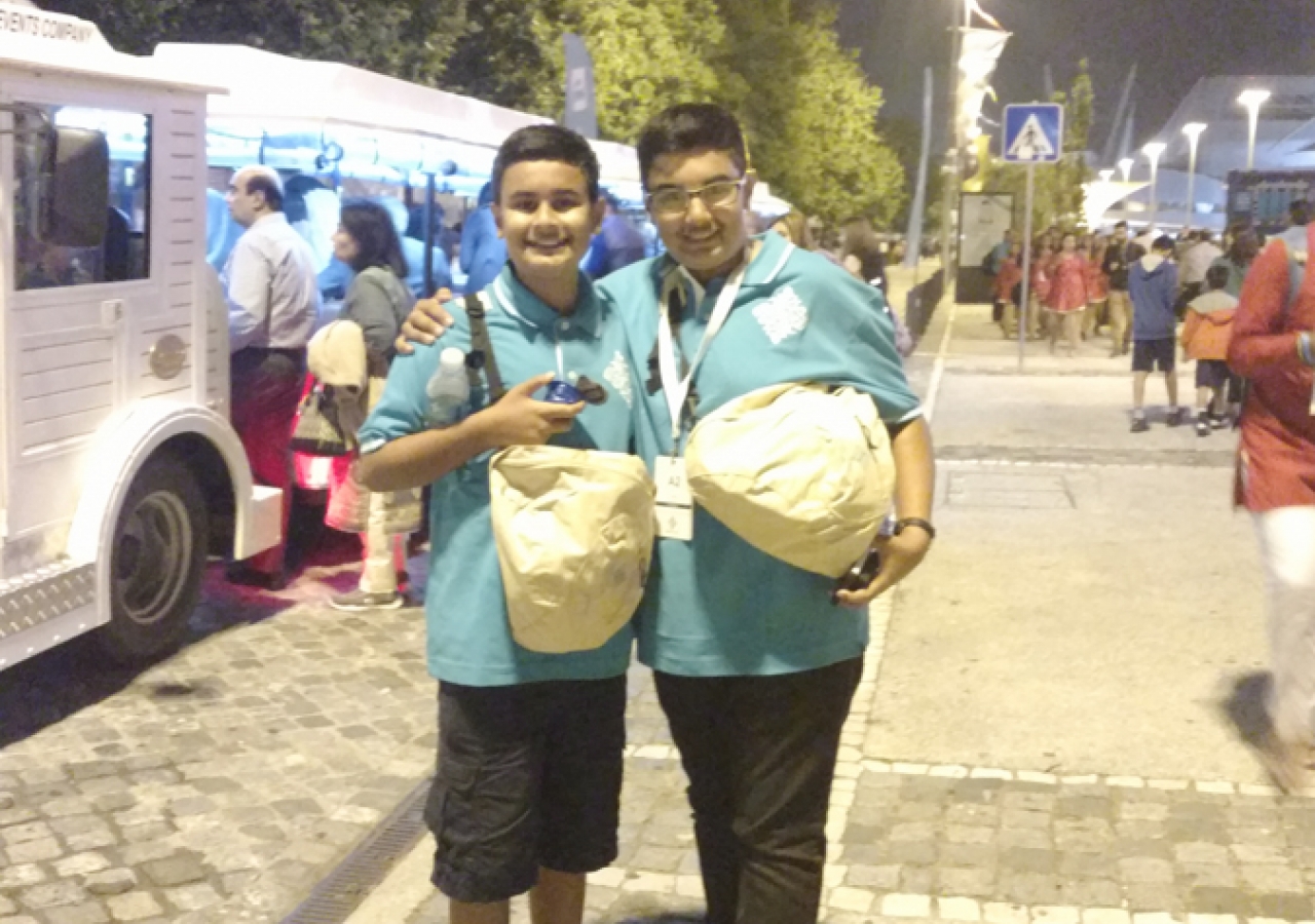 Qayl and Riyaan by the train at the Feira Internacional de Lisboa, the Darbar site.