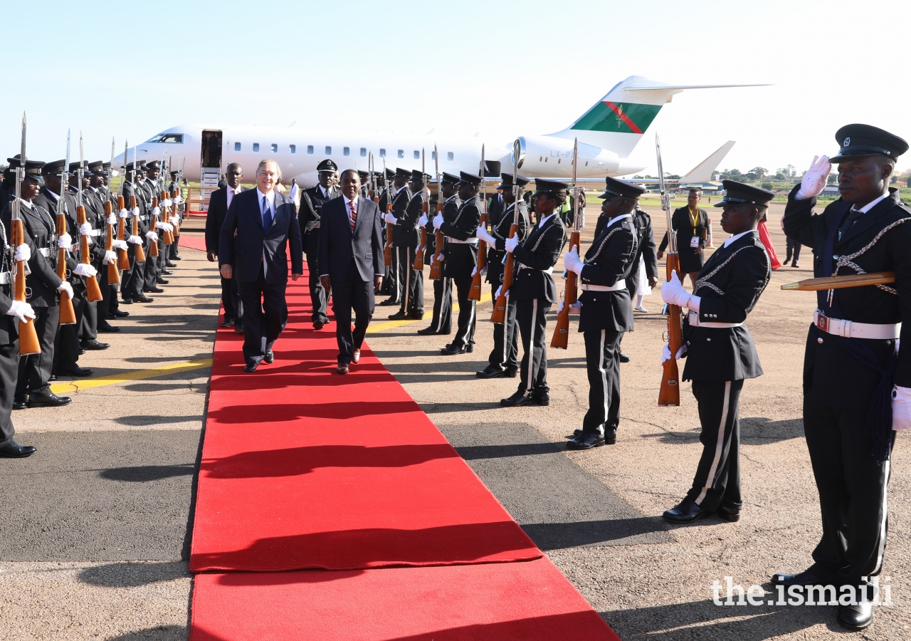 Mawlana Hazar Imam walks past a guard of honour.