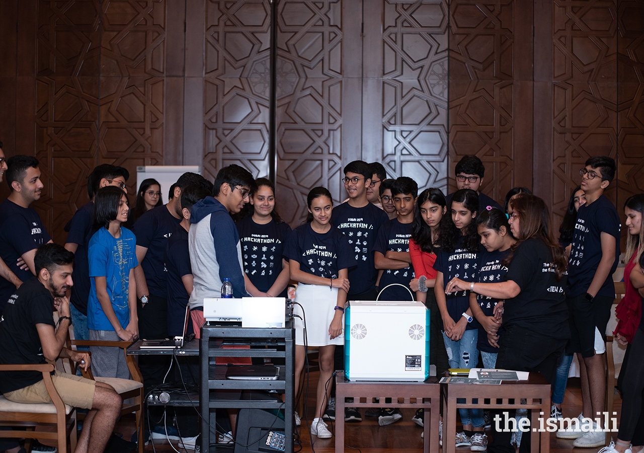 During Hackathon Dubai, participants watch a 3-D printer in action. 