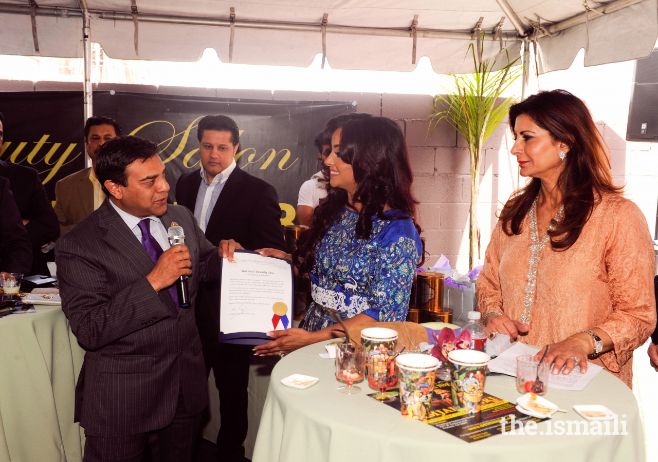 Rozina Piredina receiving an award from Ali Sajjad Taj, Mayor of Artesia, California.