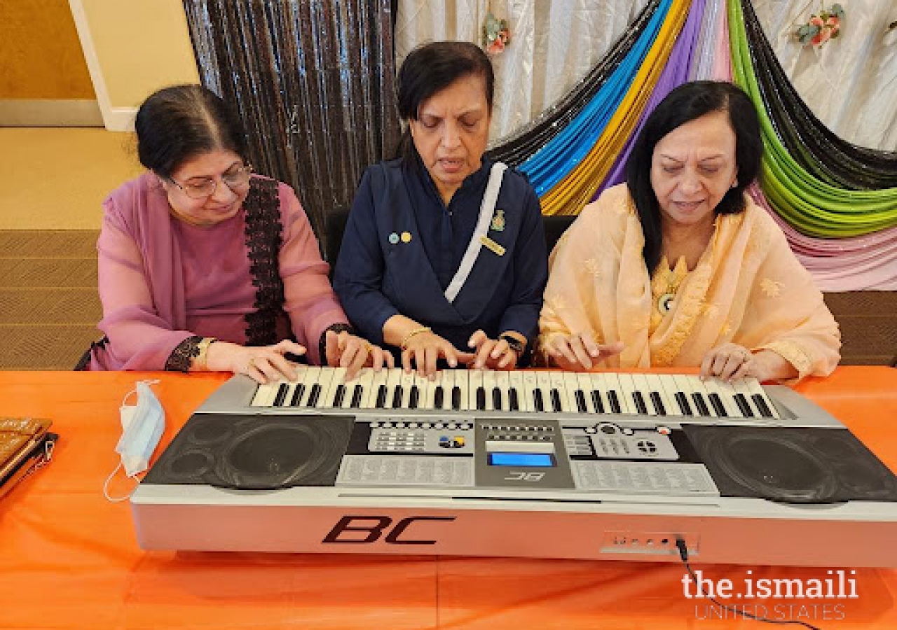 Seniors at Atlanta South Jamatkhana learning how to play piano.