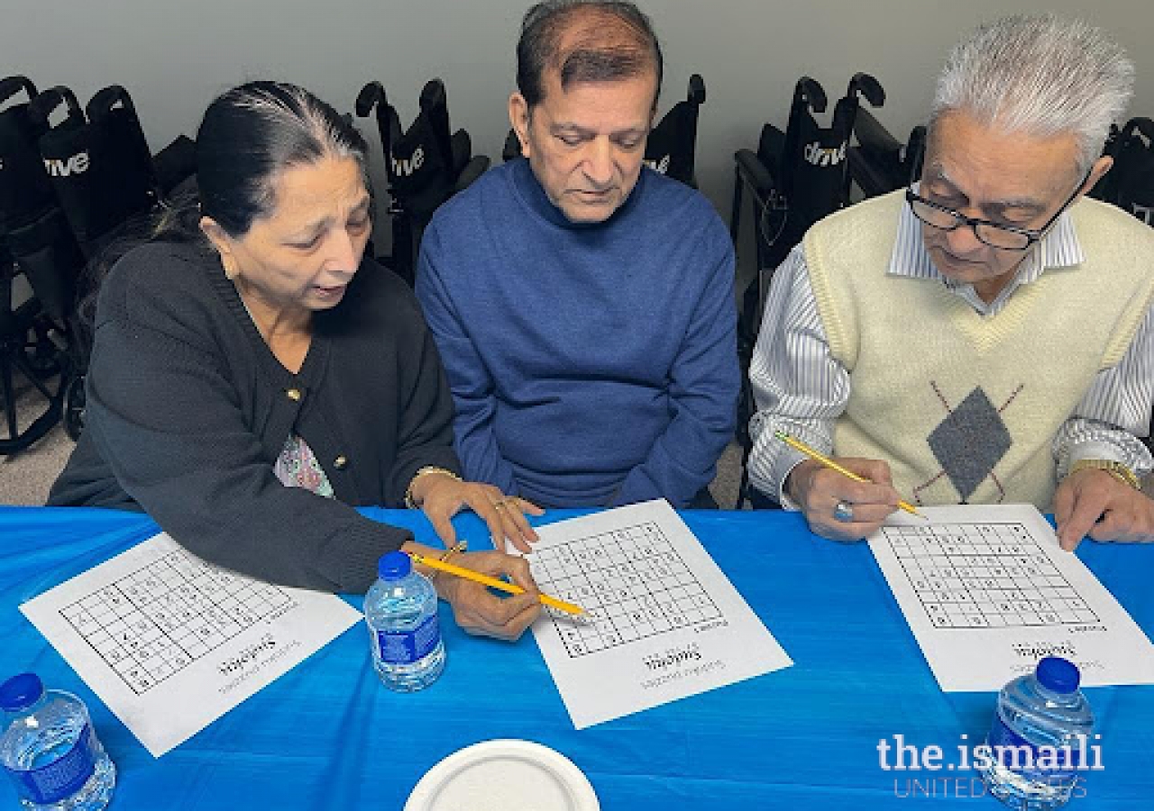 Seniors at Atlanta Northeast Jamatkhana learning how to play sudoku.