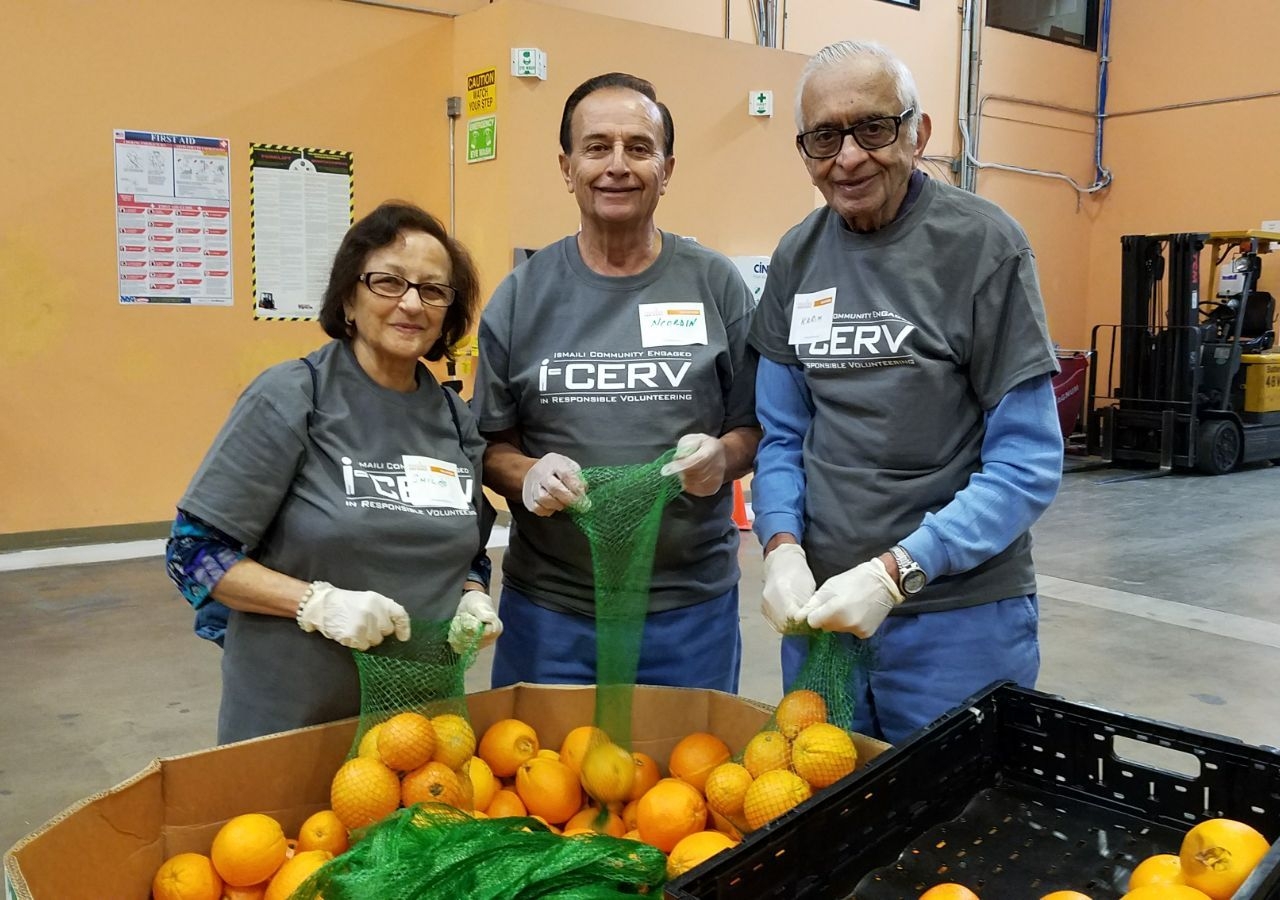 Volunteers packing oranges at the Feeding America San Diego warehouse