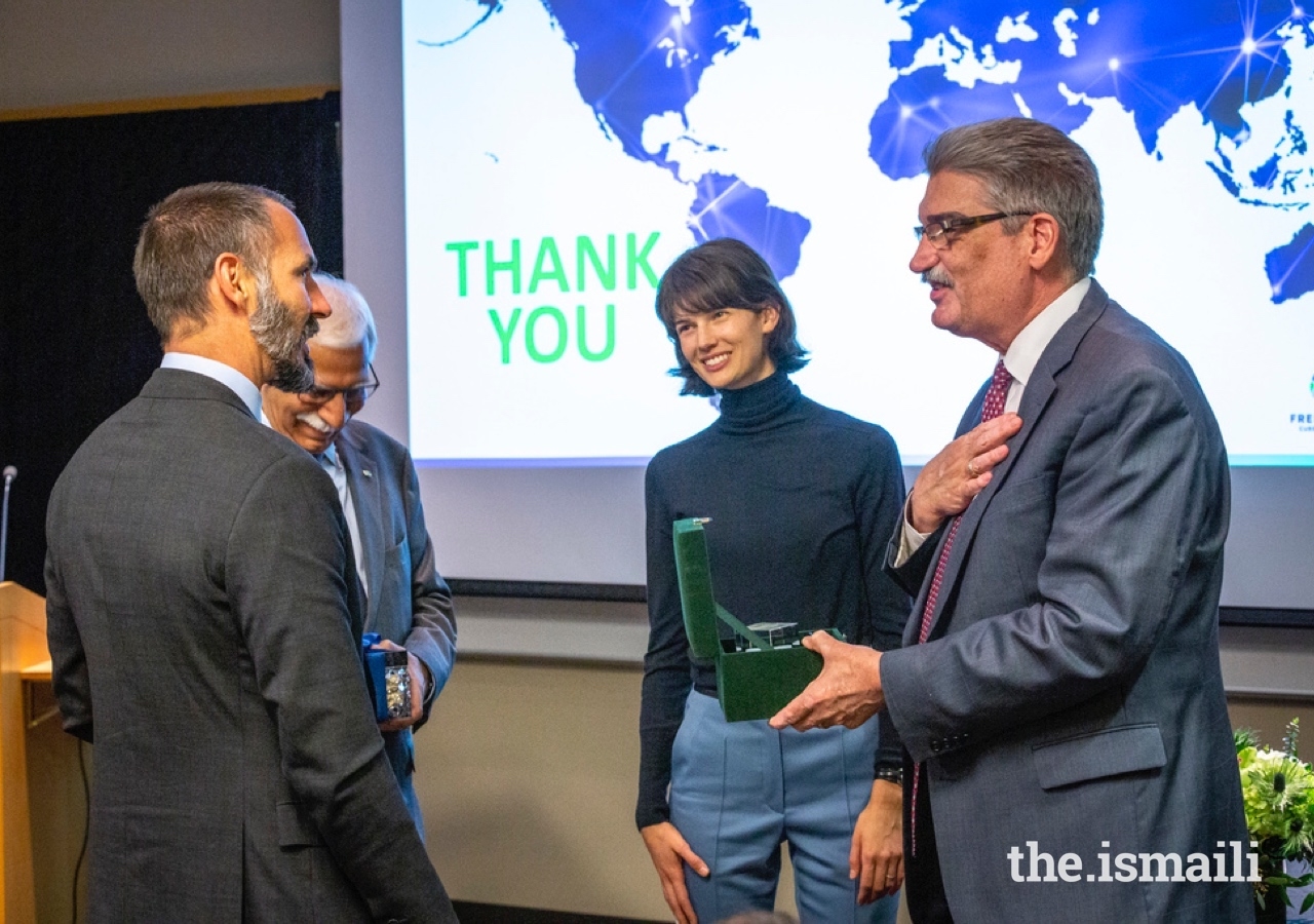 President and Director of Fred Hutch Dr. Gary Gilliland and Prince Rahim exchange gifts after the MOU signing ceremony at the Fred Hutchinson Cancer Research Center as AKU President Firoz Rasul and Princess Salwa look on.