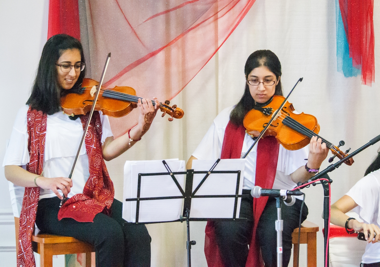 The Youth Orchestra performs rhythmic tunes on violin.