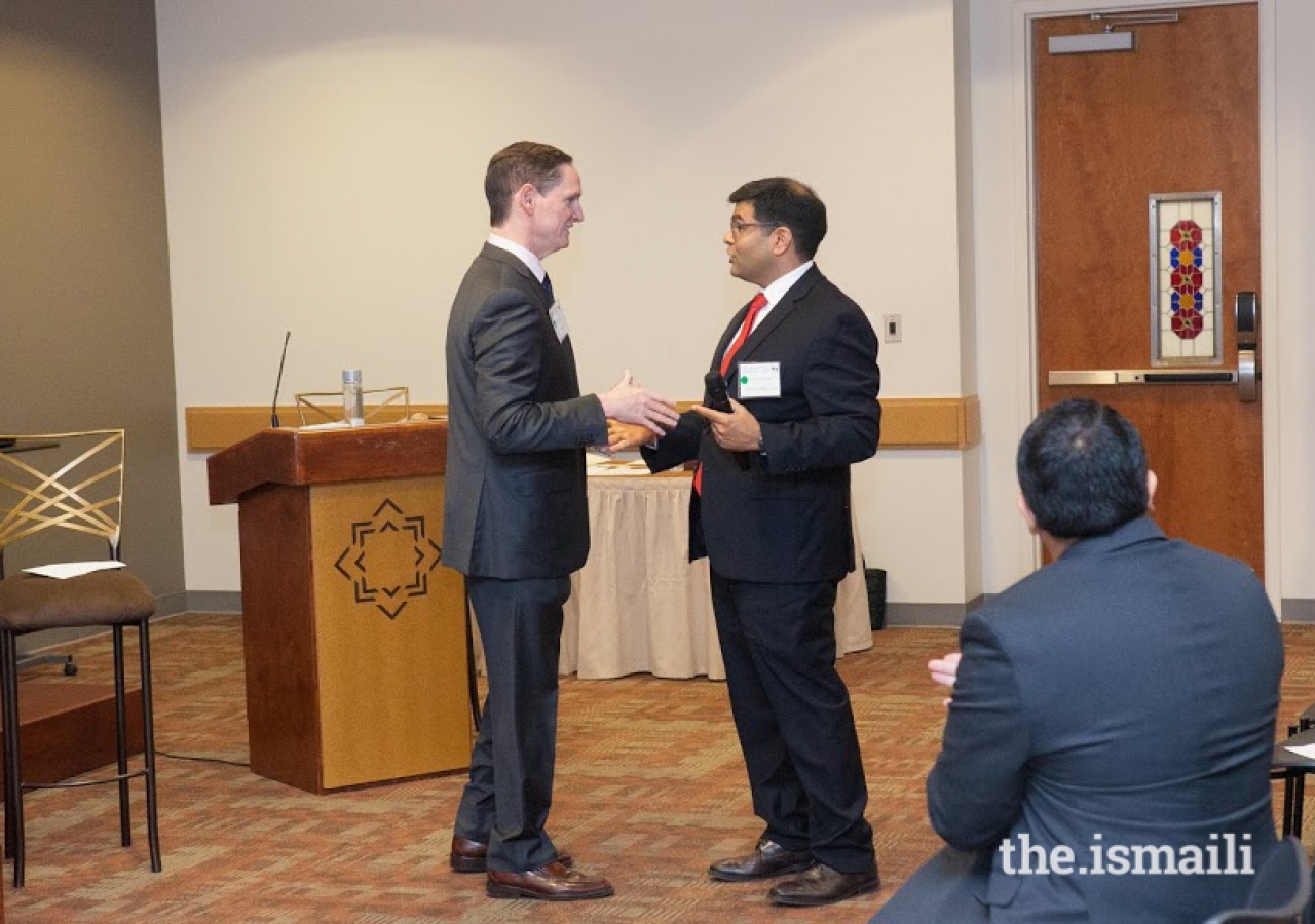 Clay Jenkins, head of the Dallas County government (left) is invited to address the assembled mediators by Kamran Jivani, National CAB Board member.