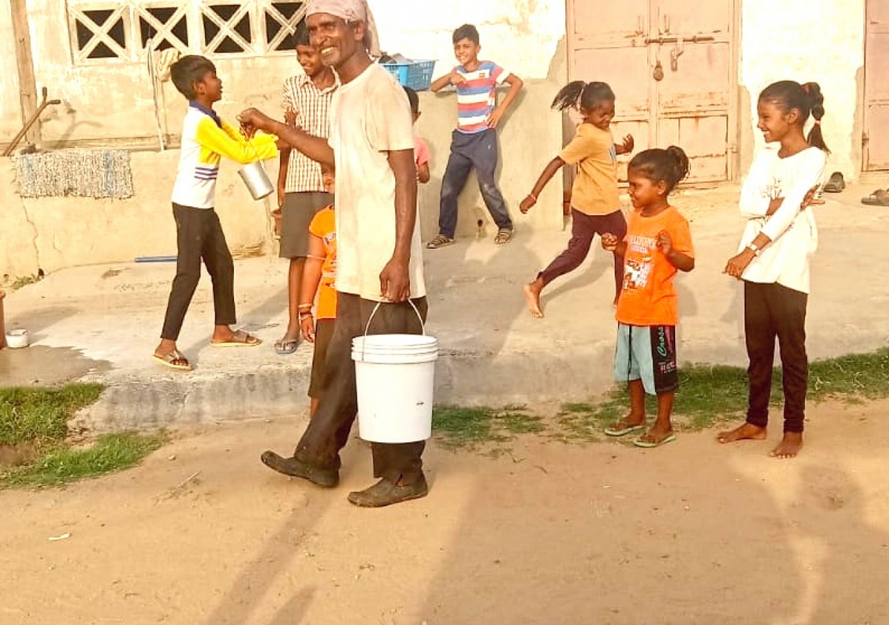 Village children share laughter and entertain the milkman, creating priceless moments of happiness.